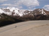 Cyclist climbing Loveland Pass - Route 6 - Road up through Loveland Pass (Colorado, USA)