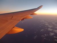 Aircraft wing in sunrise - Pacific Ocean (No State, International)